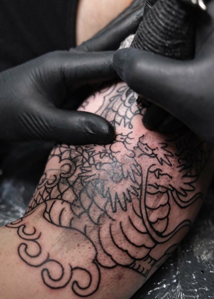 dragon outline on a cover-up tattoos in berlin