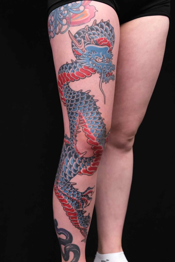 big traditional japanese dragon tattoo on the complete leg done at good old times tattoo shop in berlin