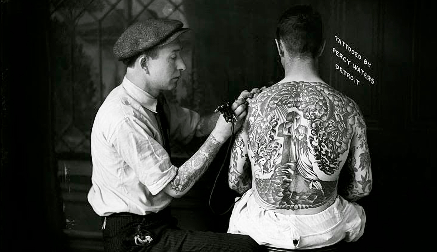 Percy Waters tattooing Rock of Ages Backpiece