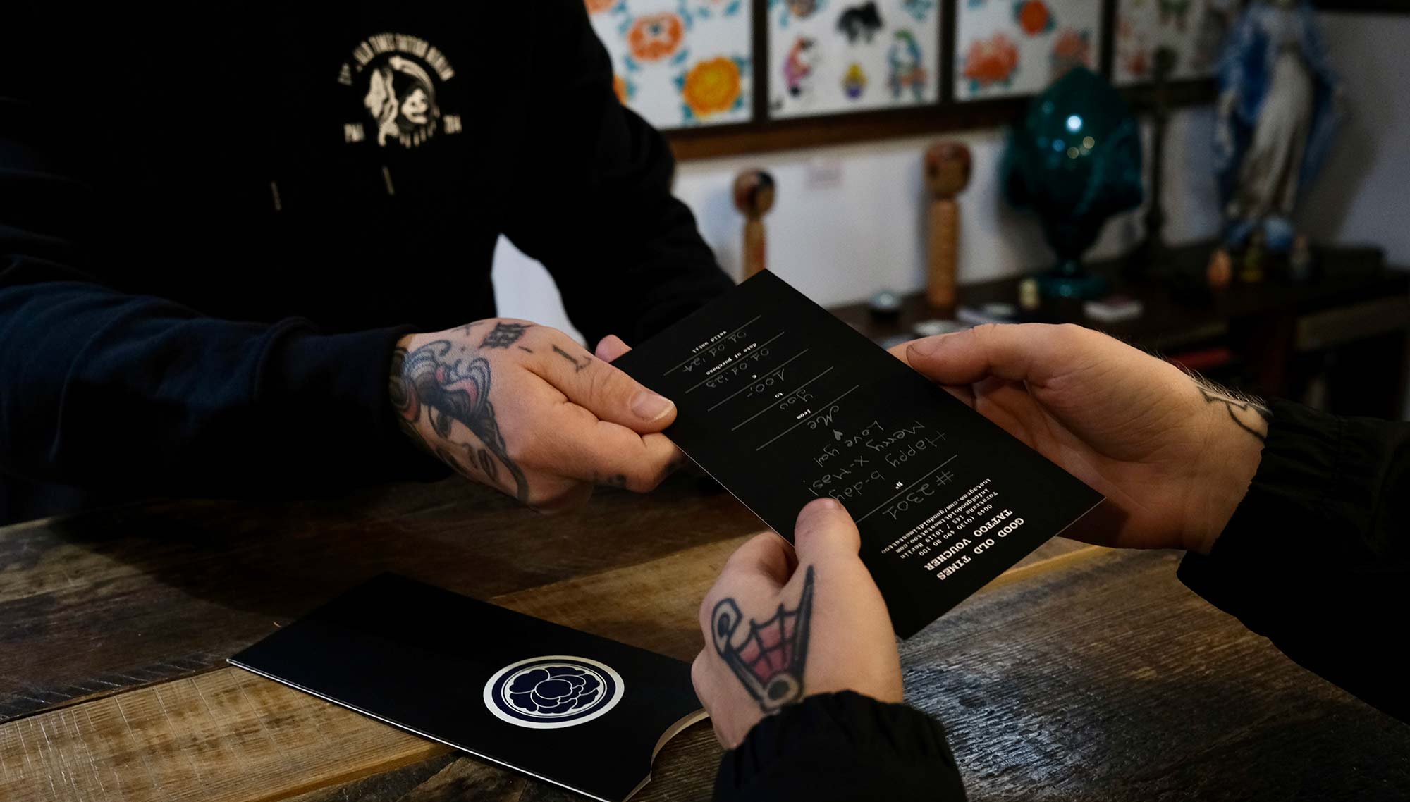 good old times tattoo presents a tattoo voucher to a customer 