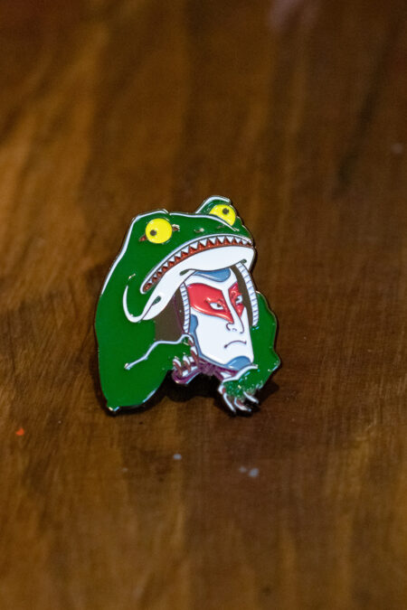 enamel pin featuring a kabuki frog front view