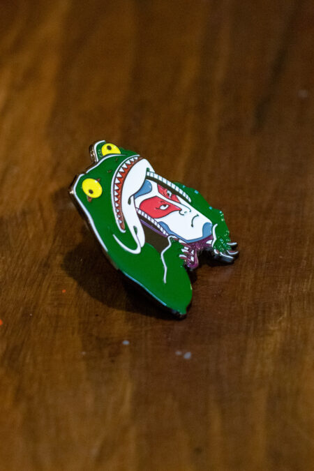 enamel pin featuring a kabuki frog side view